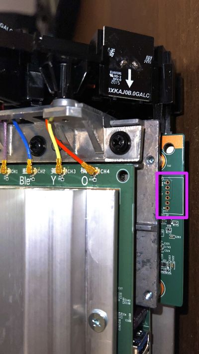 Close-up of the Linksys MX5300 with its shell removed, showing the rear of the device where the serial port is located